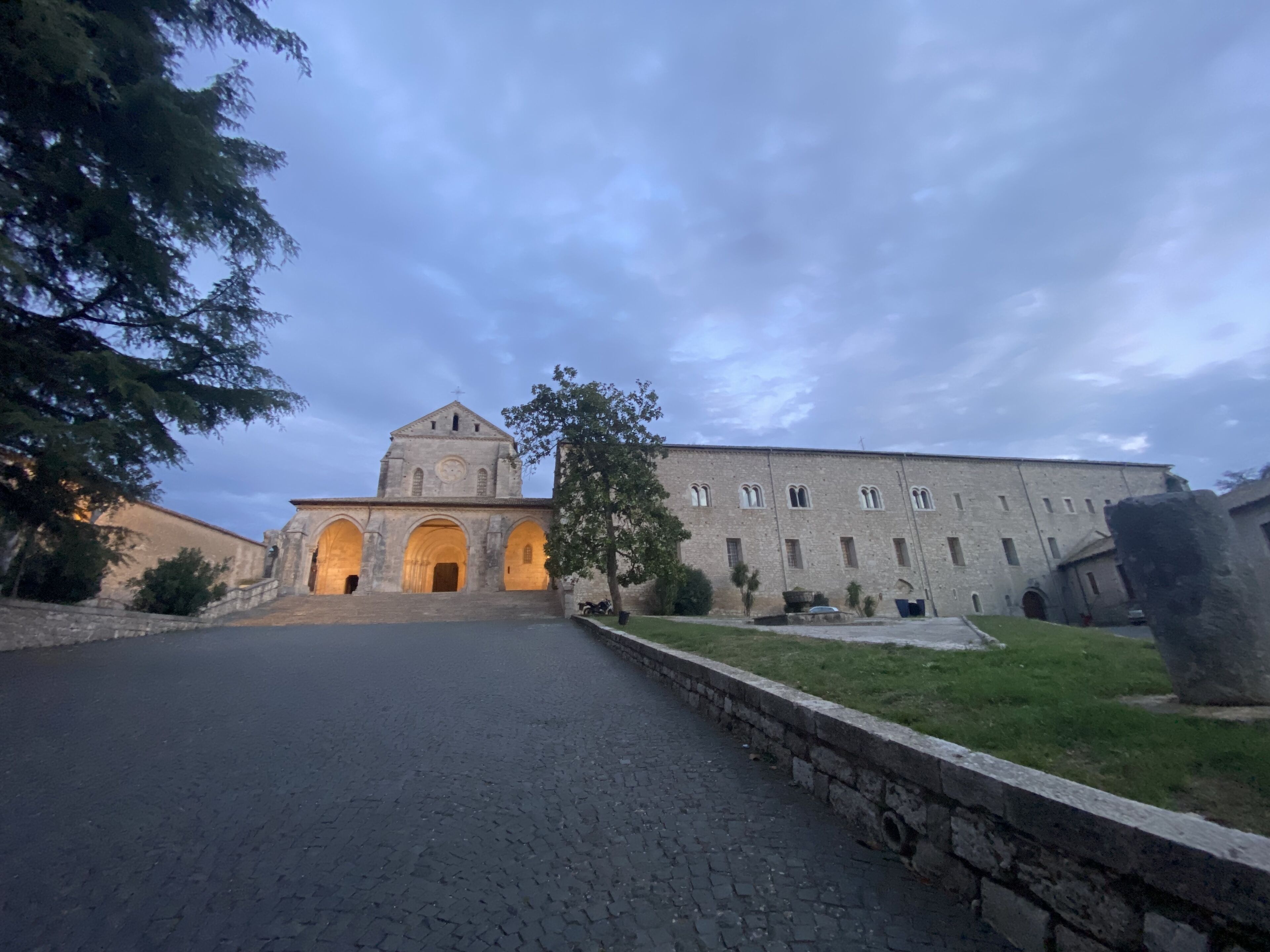 A historic building with a central tower and multiple arches.