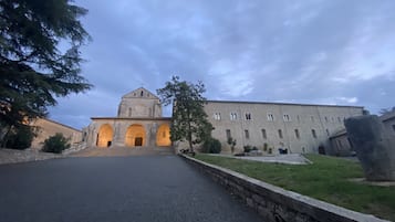 A historic building with a central tower and multiple arches.