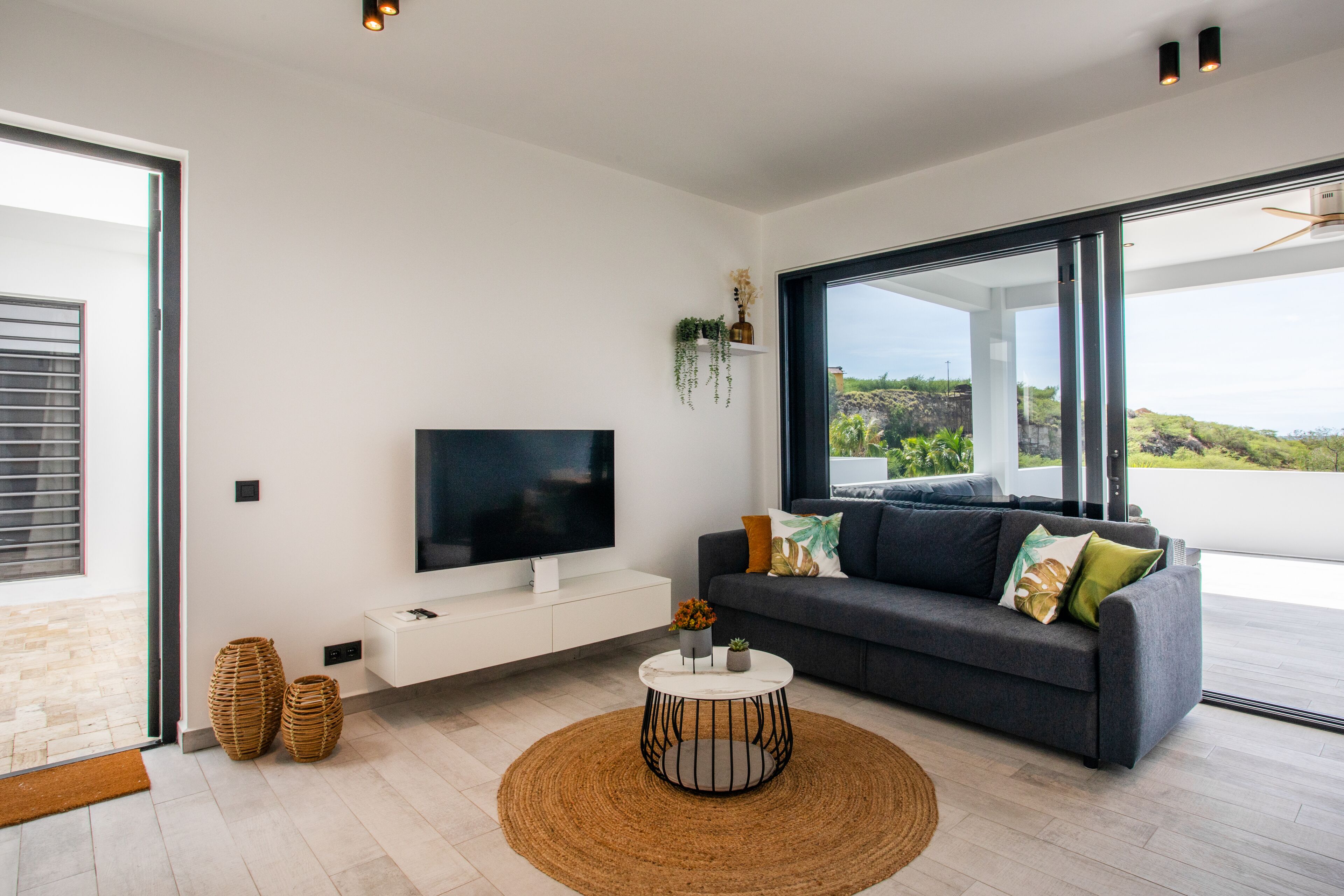 deluxe apartment | living area | 90-cm smart tv with cable channels, tv