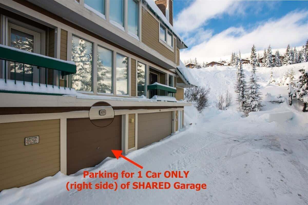 A multi-story building with a shared garage.
