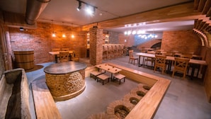 Un restaurante con paredes de ladrillo, mesas de madera y una zona de bar.