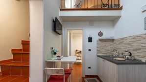 A kitchen with a dining table, chairs, a sink, and a staircase. - Holiday Home "Sg Standard" with Landmark View, Terrace & Wi-Fi (Massafra)