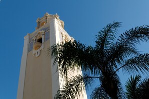 A tall tower with intricate architectural details and a clear blue sky in the background. - Perfect Downtown Space-Walk to Library, Theater, REstaurants & Shops! (Sarasota)