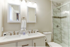 A bathroom with two sinks, a toilet, and a shower. - Cozy and Clean, Pet and Family-Friendly Gem; Minutes to Asheville (Weaverville)