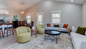 A spacious living area with a sofa, armchairs, a coffee table, and a dining area with chairs and a table. - Cozy and Clean, Pet and Family-Friendly Gem; Minutes to Asheville (Weaverville)