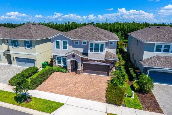 A residential area with two houses, each with a garage, driveway, and well-maintained landscaping.