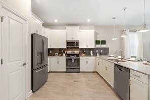 Enjoy cooking in this well-equipped kitchen with a large island, oven, and ample counter space.