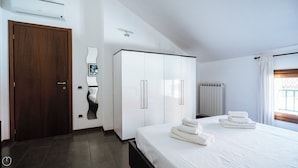 A hotel room with a bed, a wardrobe, a door, and a radiator. - Viale Hambury 51 (Alassio)