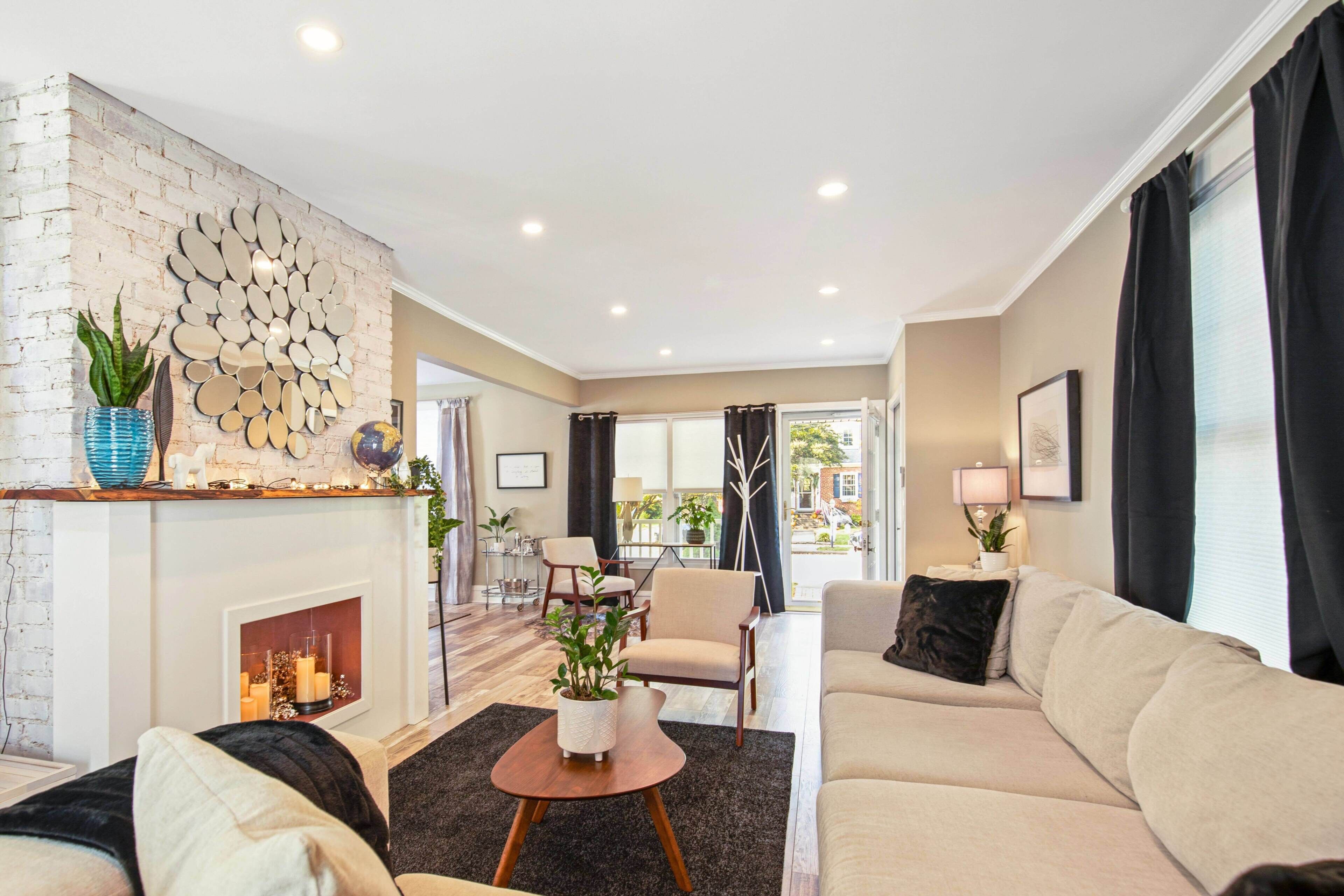 Cozy living room with faux fireplace, perfect for family gatherings. 