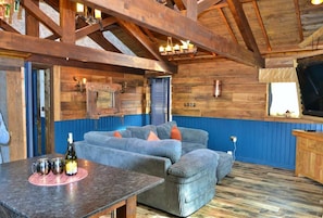 Relax in this inviting space with a plush sofa and a small table for intimate gatherings.
