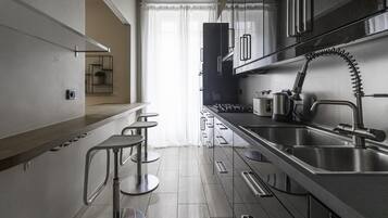 Comfort Apartment | Private kitchen | Full-sized fridge, microwave, electric kettle, toaster