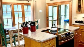 A kitchen with a wooden island, stainless steel appliances, and a sign that reads "Welcome to Our PLACE".