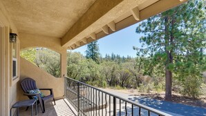 A covered balcony with a view of a road and trees. - Colfax Getaway w/ Hot Tub, Mountain Views! (Colfax)