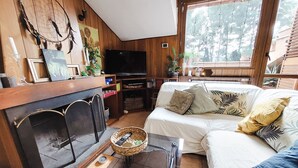 A cozy living room with a fireplace, a television, and a comfortable sofa. - La Mansardina (Roma)