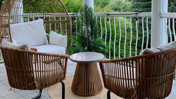 A covered outdoor seating area with wicker furniture and a view of mountains. - Fairmont Oasis | Luxury | Views | Bright | Nature (Fairmont Hot Springs)
