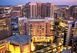 A multi-story building with the sign 'MD Anderson Cancer Center' indicating a medical facility.