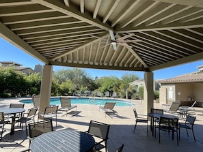 A covered outdoor area with a pool, lounge chairs, and tables. - Spacious Townhome in North Scottsdale Grayhawk Gated Community (Scottsdale)