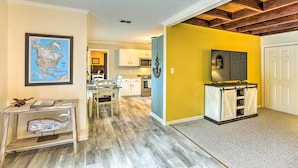 A modern kitchen with white cabinets, a wooden ceiling, and a yellow accent wall. - Waterfront Home: Spectacular On-Site Fishing! (Panacea)
