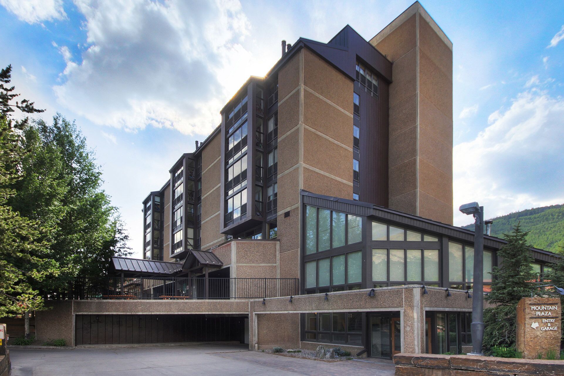 A multi-story building with a prominent entrance, large windows, and a sign indicating a garage.