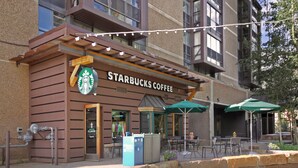 A Starbucks Coffee with outdoor seating and a sign indicating a daily summit. - Perfect Ski-In/Ski-Out Hotel Room, Steps to American E Chairlifts, Hot Tub (Copper Mountain)