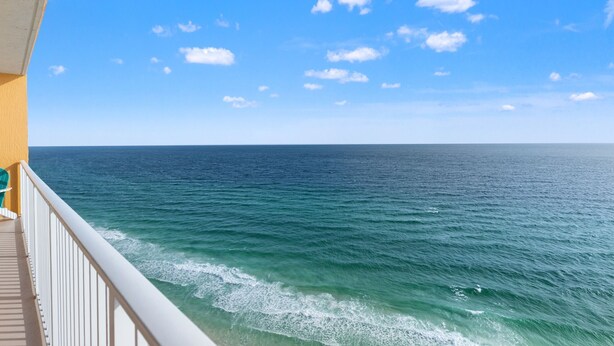A balcony with a view of the ocean and a clear sky. - Treasure Island 1806 (Panama City Beach)