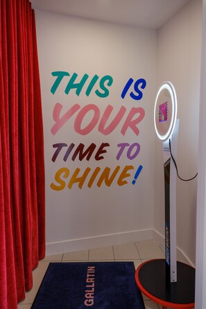 A room with a motivational wall message, a vanity mirror, and a red curtain. - The Gallatin (211) East Nashville Boutique Hotel (Nashville)