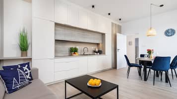 Deluxe Apartment | Living area | 55-inch LED TV with digital channels, TV