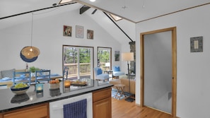 A spacious kitchen with a large island, wooden cabinets, and a view to the outdoors. - Tranquil Lake Retreat•Dog-Friendly•Lakes•Pools•Beaches•Spacious Family Escape (Lake Ariel)