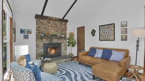 Smart TV, chimenea, libros y biblioteca musical 