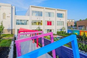 Stunning residential building with a flat roof and symmetrical facade, featuring large windows and a beautifully maintained garden.