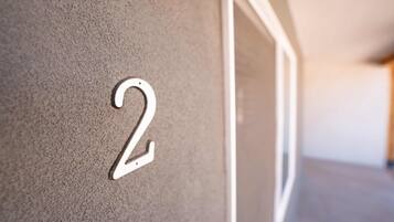 A close-up of a wall with a number '2' indicating a room or unit number.