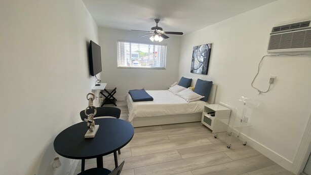 A compact, well-lit room with a bed, a small table, and a ceiling fan. - Excellent location Miami Brickell Studio 1.7 Miles from the Beach (Miami)