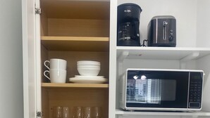 A compact kitchen with a built-in microwave, a coffee maker, and a toaster. - Excellent location Miami Brickell Studio 1.7 Miles from the Beach (Miami)