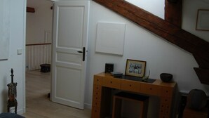 A room with a wooden desk, a white door, and a staircase. - 2 room loft Rue de la Croix / Cannes (Cannes)