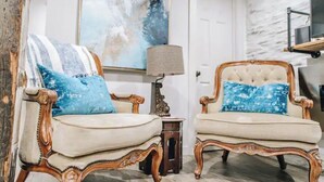 A room with two ornate armchairs, a small table, and a painting on the wall. - Stunning Ground Floor Apartment in Green Ridge. (Scranton)