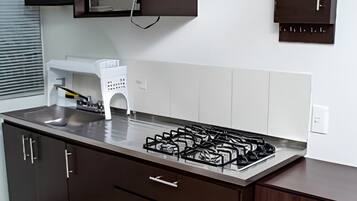 Microondas, cafetera y tetera, utensilios de cocina y comedor