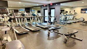 A gym with treadmills, ellipticals, and weight machines.