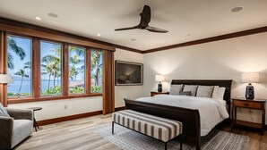 Une chambre dotée d’un grand lit, d’un ventilateur de plafond, et offrant une vue sur les palmiers et la plage, grâce à de grandes fenêtres.