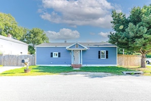 A single-story house with a front porch, a mailbox, and a small front yard.