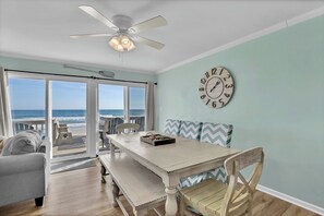 A dining area with a wooden table, benches, and a clock on the wall. - "Island Time", Peaceful 5BR Oceanfront Cottage (Surf City)