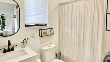 Combined shower/bathtub, towels, soap, toilet paper
