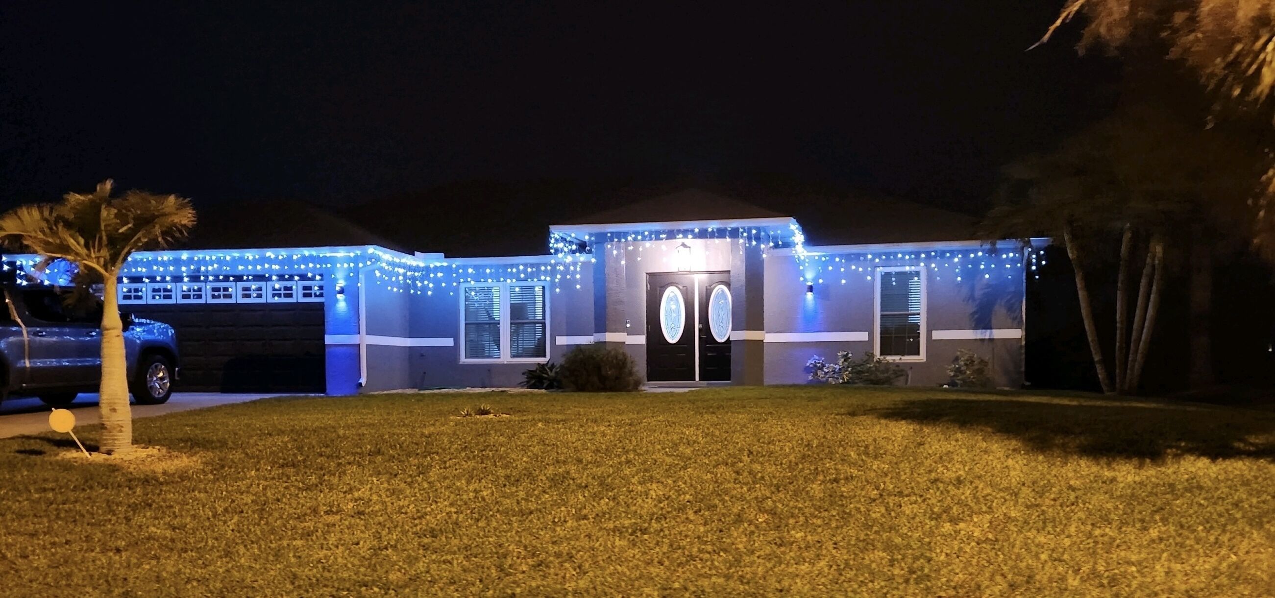 A house with a garage, a front door, and a driveway.