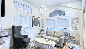 A modern living room with a sofa, armchair, and coffee table.