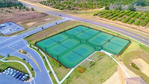 An aerial view of a sports complex with multiple tennis courts, a parking lot, and surrounding greenery. - (JH1543) Champions Gate Home 6/5 Private Pool & Jaccuzi, Free Waterpark (Davenport)