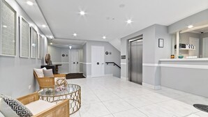 A modern interior with a dining area, a staircase, and a kitchen.