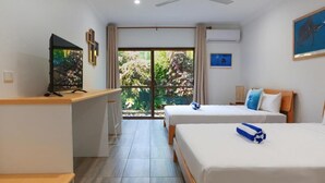 A hotel room with two beds, a desk, a television, and a sliding glass door to a balcony. - Birch Resort Port Douglas (Port Douglas)
