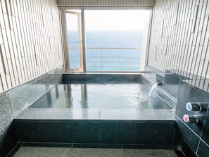 Bathroom | Separate bathtub and shower, free toiletries, hair dryer, slippers