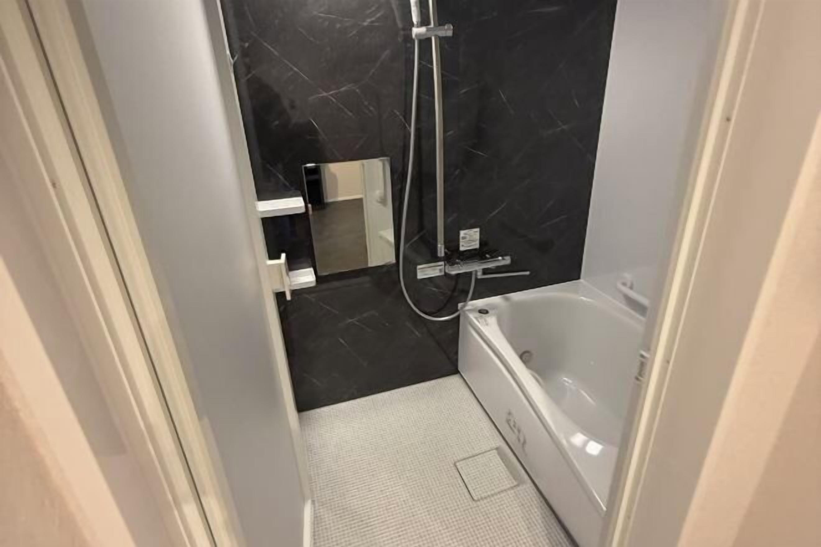 Badkamer | Een aparte badkuip en douche, gratis toiletartikelen, een haardroger