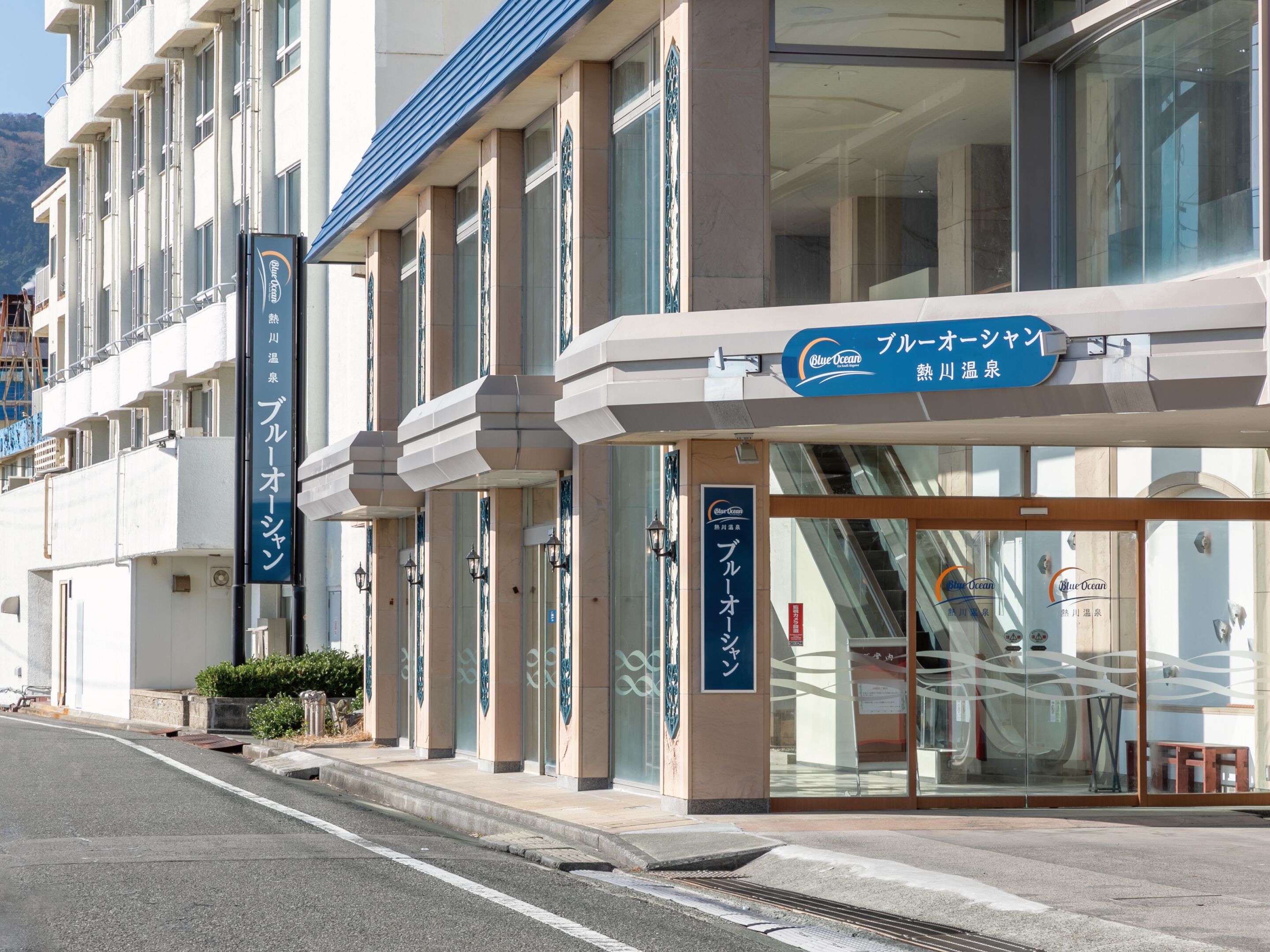A hotel with a modern facade, featuring large windows and a sign indicating it is a Blue Ocean hotel.