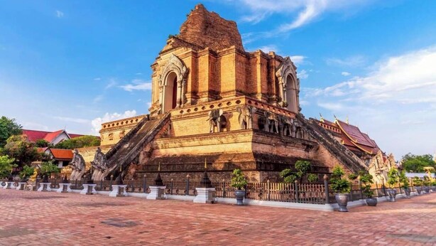 A historical temple with a large central structure, a staircase leading up to it, and a paved courtyard. - Wualai Boutique by Lanna Oriental (Chiang Mai)